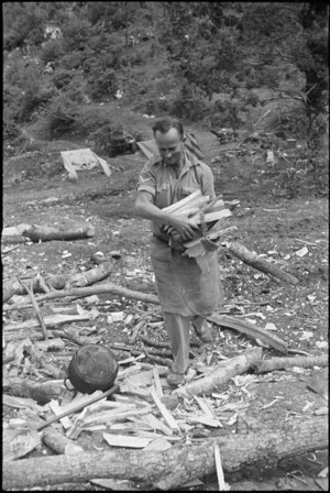 A A Brown with supply of wood for his cookhouse in hills near Cassino, Italy, World War II - Photograph taken by George Kaye