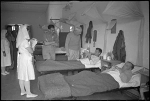 Prime Minister Peter Fraser talking to patient S A McCauley at 2 New Zealand General Hospital, Caserta, Italy, World War II - Photograph taken by George Kaye