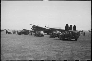 Official cars drawing away from aircraft at Bari Airport, Italy, following arrival of NZ Prime Minister - Photograph taken by George Bull