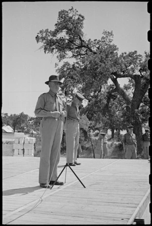 Prime Minister Peter Fraser uses microphone to address troops at NZ Advance Base in Italy, World War II - Photograph taken by George Bull