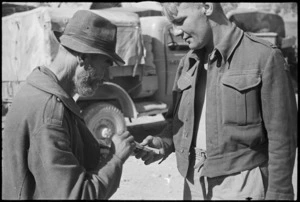 G V Mickie gives cigarette to an aged civilian in the town of Atina, Italy, World War II - Photograph taken by George Kaye