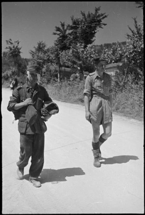 Enemy prisoner, captured near Sora, Italy, is brought along the road - Photograph taken by George Kaye