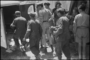Enemy walking wounded entering American Field Service ambulance outside Vicalvi, Italy, World War II - Photograph taken by George Kaye
