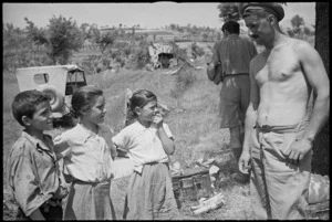 A G Trotter talks to three children who have wandered into artillery positions near Sora, Italy, World War II - Photograph taken by George Kaye