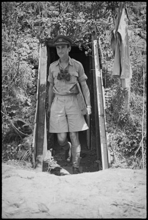 Lieutenant B Bookman coming out of a dugout used by 29 Battery of 6 NZ Field Regiment near Sora area, Italy, World War II - Photograph taken by George Kaye