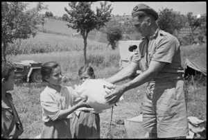 R T Stewart hands washing to Italian children near Sora, Italy, World War II - Photograph taken by George Kaye