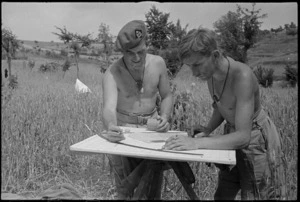 I E Gilbert and W S Tuck at work on artillery board in a wheatfield near Sora, Italy, World War II - Photograph taken by George Kaye