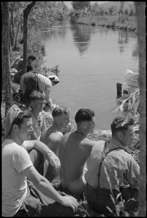 New Zealanders enjoying sunshine on banks of the Fibrino River in Italy during World War II - Photograph taken by George Kaye