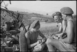 New Zealand anti aircraft gunners writing and chatting beside their gun near Sora, Italy, World War II - Photograph taken by George Kaye