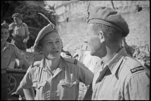 A T Wilson and L N Carter, members of 26 NZ Battalion, decorate their berets with feathers in Sora, Italy, World War II - Photograph taken by George Kaye
