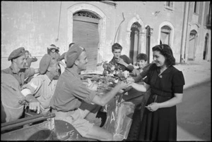 Young woman of Sora, Italy, gives flowers to New Zealanders in World War II - Photograph taken by George Kaye