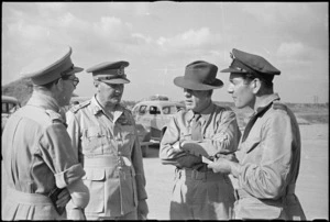 Prime Minister Peter Fraser with General Freyberg and others on Pamigliano Airfield before travelling to Rome, World War II - Photograph taken by George Bull
