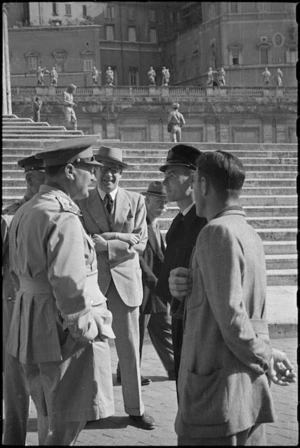 General Bernard Freyberg and others chat with Vatican official while awaiting Peter Fraser's return from his papal audience, Italy, World War II - Photograph taken by George Bull