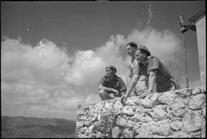 W W Tathan, T R Wilson and H J LeGaul on wall of the ancient castle above Vicalvi, Italy, World War II - Photograph taken by George Kaye