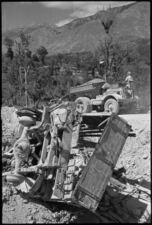 Dumptor used to repair bridge passes wrecked enemy vehicle between Sora and Avezzano, Italy, World War II - Photograph taken by George Kaye