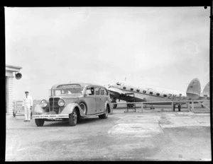 Loading baggage on to bus with Lodestar aircraft in background at New Zealand National Air Corporation, Rongotai, Wellington