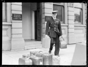 Commissionaire carrying baggage from office, Wellington NZNAC (New Zealand National Air Corporation)