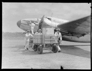 New Zealand National Air Corporation Loading staff at work, Rongotai Wellington, includes Lodestar aircraft "Kawatere" and staff in uniform