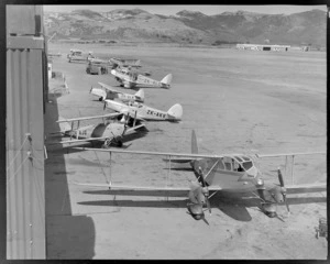Rongotai airport, Wellington, showing aircraft lined up on tarmac, including a De Havilland Rapide aircraft Tara, ZK-AJQ, ZK-AKV, Auster ZK-ALW and ZK-ALC