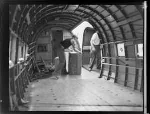 New Zealand Air Force, freight service, worker inside Dakota Aircraft Paraparaumu, Wellington