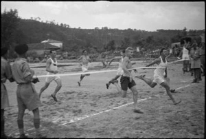 M P Donnelly wins 100 yards championship at 4 NZ Armoured Brigade sports meeting at Isola del Liri, Italy, World War II - Photograph taken by George Kaye