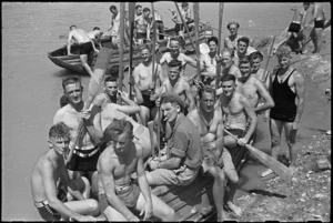 Boat crews waiting to take part in the 'Napoli Nebelwerfer's Nudge' at 24 NZ Battalion's aquatic derby at Arce, Italy, World War II - Photograph taken by George Kaye