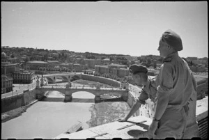 W M Everest and A M Horneman on leave in Rome, Italy, look across the Tiber towards the city - Photograph taken by George Kaye
