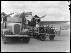 New Zealand National Airways Corporation Lockheed L-18 Lodestar 'Kotare', ZK-AJM, showing luggage being unloaded at Rongotai Airport, Wellington