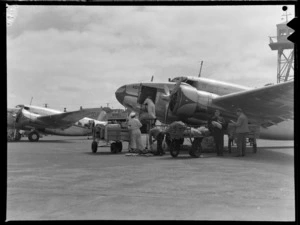 New Zealand National Airways Corporation Lockheed L-18 Lodestar 'Kotare', ZK-AJM, being unloaded at Rongotai Airport, Wellington
