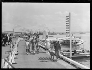 Unidentified passengers and crew disembarking from the TEAL Short Tasman class Sunderland Flying Boat ZK-AME at Mechanic's Bay, Auckland City