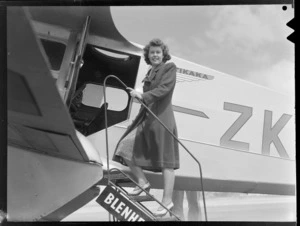 An unidentified female passenger boarding a New Zealand National Airways Corporation Dragon Rapide aeroplane 'Tikaka', at Rongotai Airport, Wellington, before departure to Blenheim
