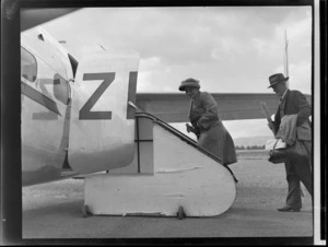 Two unidentified passengers boarding a New Zealand National Airways Corporation aeroplane