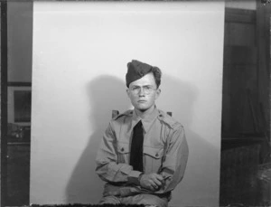 Portrait of LAC (Leading Aircraftman) R S Britton in RNZAF uniform, indoor location unknown