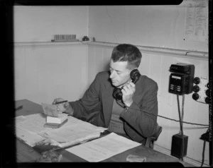 Portrait of Doctor Haskell PhD, an aerodromes engineer, sitting at a desk within an unidentified office, Wellington
