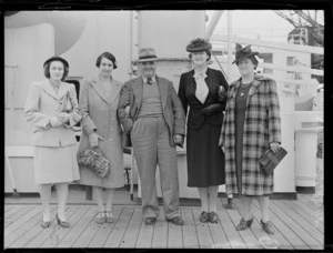 A group portrait showing Mr and Mrs G Roots, (2nd & 3rd from the left), with three unidentified women on board the ship Rakaia