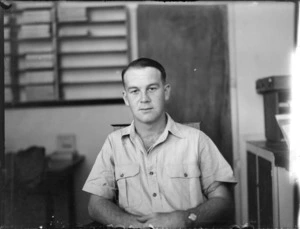 Portrait of Mr Flight Sergeant P D Wells RNZAF within unknown office, [Auckland?]