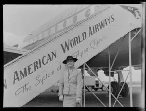A portrait of Mary Walker Sinclair standing in front of a PAWA (Pan American World Airways) passenger gangway, Whenuapai Airbase, Auckland