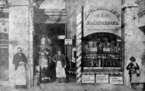 Louis P Christeson alongside his hairdressing and tobacco shop on Vivian Street, Wellington