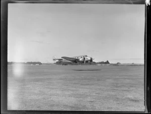 NZNAC (New Zealand National Airways Corporation) Lockheed Electra ZK-ALH 'Kopeke' aeroplane, in mid flight, Mangere airport, Auckland