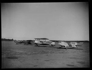 A line up of small aeroplanes at Mangere Airport, Auckland, including a Rearwin Sportster, ZK-AKF, and an Auster J-1B Autocrat, ZK-AOB