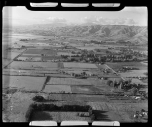 View of pastoral fields and houses with mountains beyond, Nelson Region