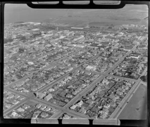 View southwest over downtown Invercargill City with Queens Park in foreground to the New River Estuary beyond