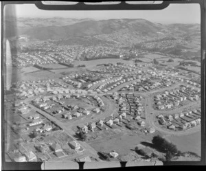 View of an unidentified Dunedin suburb on a hill with parks and [golf links?] overlooking Dunedin City, Otago Region