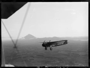 Fokker F VII monoplane 'Southern Cross' VH-USU in flight near Mount Taranaki, during arrival of Charles Kingsford Smith from Australia