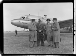 Portrait of (left) Mr Price Chairman of the Wellington Harbour Board and Mr Gibson (2nd from right) of Civil Aviation with two unidentified men in front of visiting British Vickers Viking passenger plane G-AJJN, location unknown