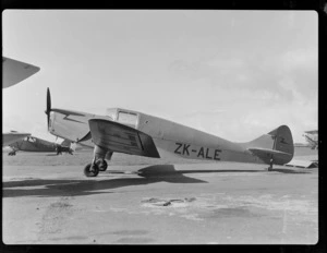 View of [Auckland Aero Club member J Gould's?] Miles M.11A Whitney Straight ZK-ALE aeroplane at an unknown [Auckland?] air field