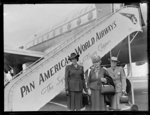 Portrait of Laura Tanner and two unidentified women in front of a Clipper Class Pan American World Airways aeroplane and gangway, Whenuapai Airfield, Auckland