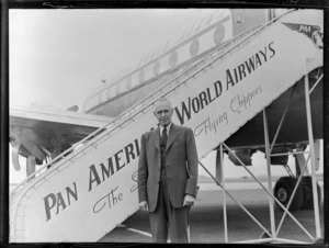 Portrait of an unidentified older man in front of a Clipper Class Pan American World Airways aeroplane and gangway, Whenuapai Airfield, Auckland