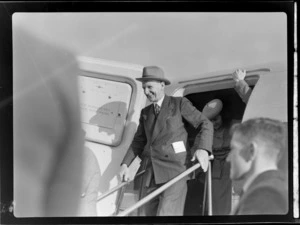 View of (L to R) Colonel C W Salmon and an unidentified woman disembarking visiting British Vickers Viking passenger plane G-AJJN, location uknown