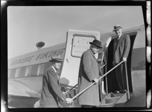 View of (L to R) Colonel C W Salmon, Prime Minister Peter Fraser and Mr Dickson boarding visiting British Vickers Viking passenger plane G-AJJN, location unknown